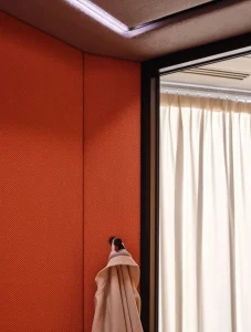Interior acoustic wall panels inside Coda acoustic booth with coat hook
