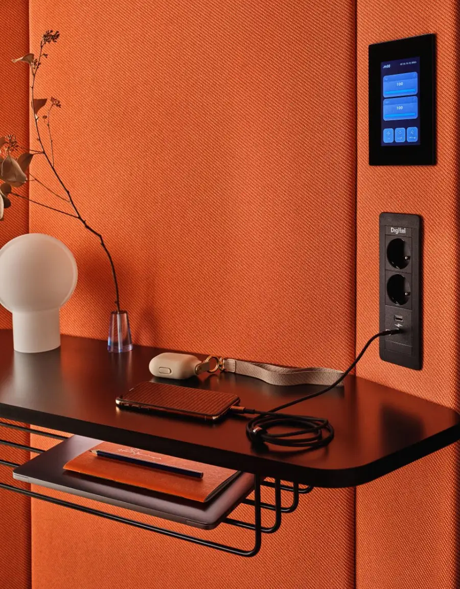 Interior workspace inside Coda acoustic booth with shelf, charging ports and control panel